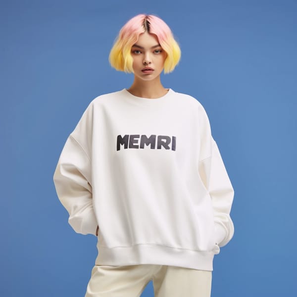 Woman with pink and yellow hair in white sweatshirt and white pants, posing for the camera.