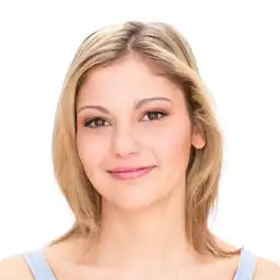 This is a young blonde girl on the face expression changer, and she is smiling.