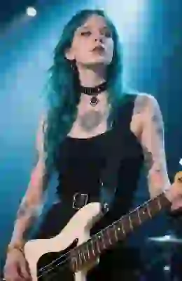 Female bassist with blue hair and tattoos enhanced by AI image generator