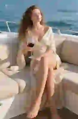 Woman in elegant dress on luxury yacht created using AI photo transformation