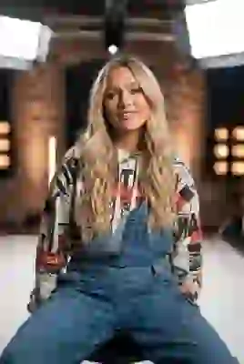 Portrait of a blonde hippy woman in denim overall and printed sweatshirt. Template for AI image to image.