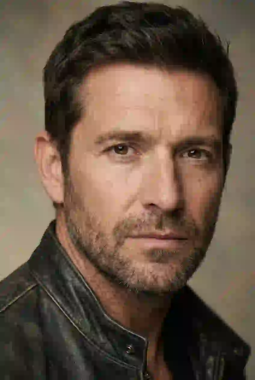 Portrait of a handsome man with subble in leather jacket. Template for AI baby filter.