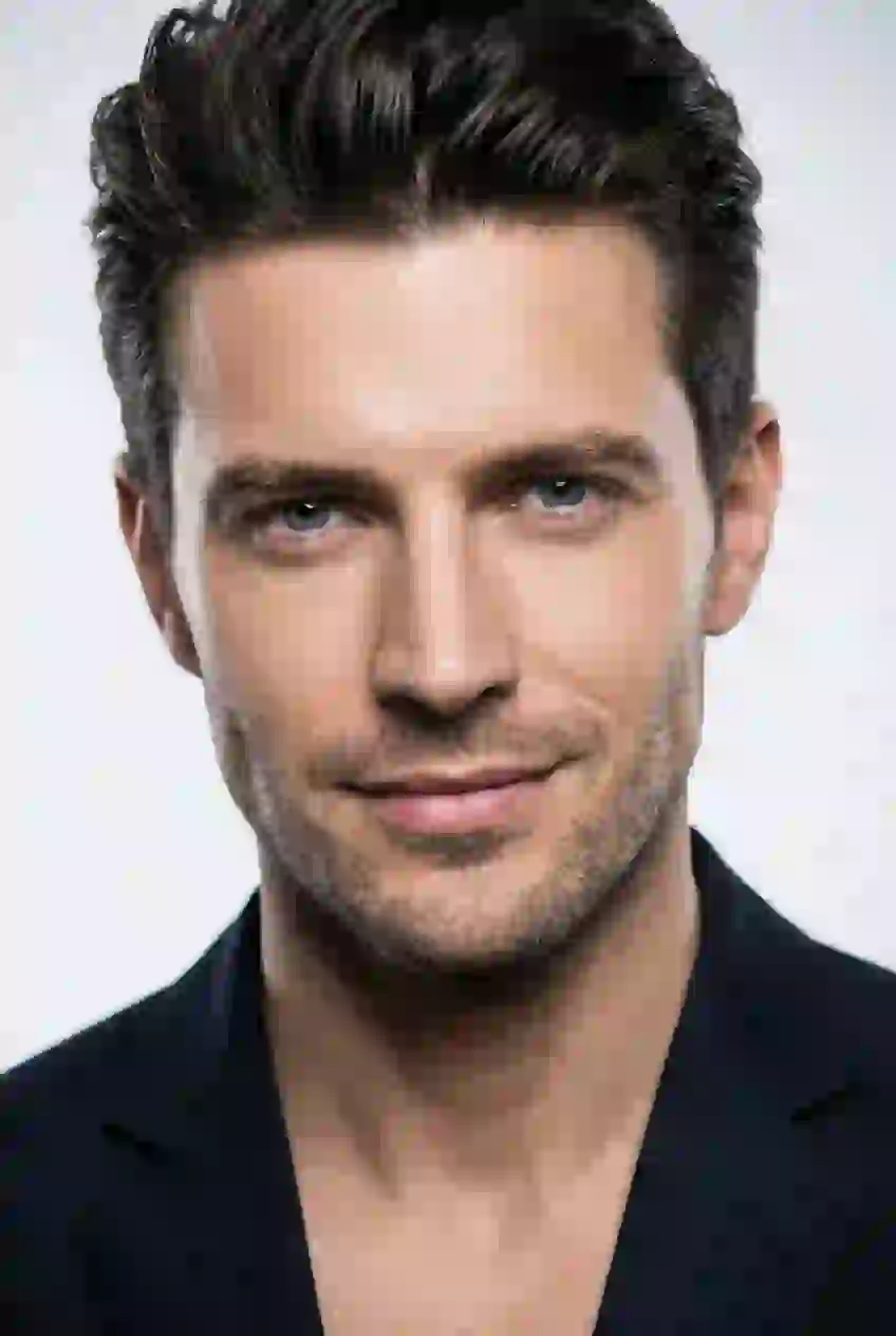 Portrait of a smiling handsome man with blue eyes. Template for AI baby filter.