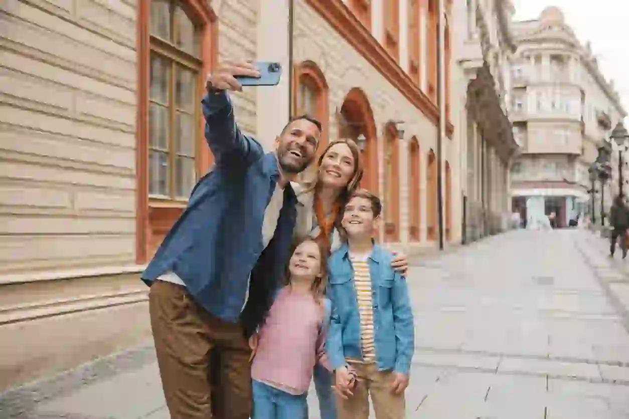 This is a vlog screenshot of a family traveling in the streets of Europe, as a sample before the multiple face swap video. There are four faces in the video: the dad, mom, younger son, and younger daughter.