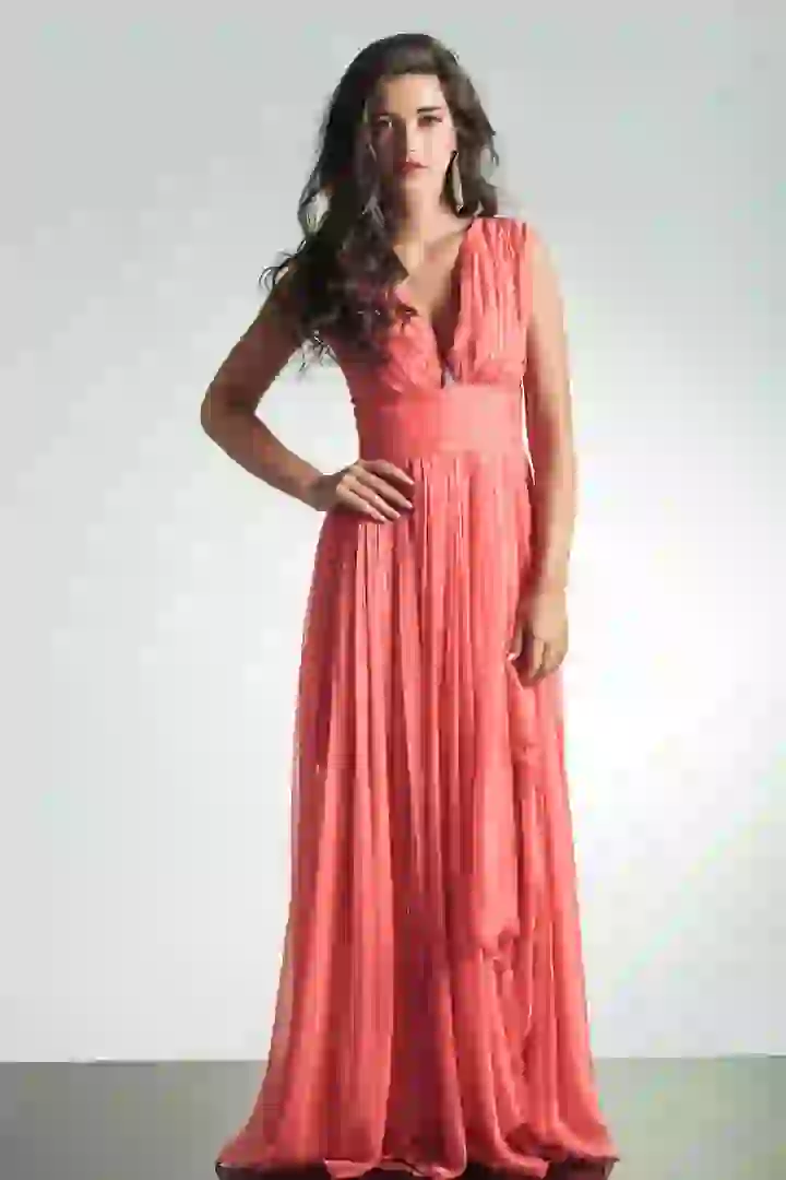 A stylish young white woman stands ready for a change of clothing. Users can click to change her pink long dress.