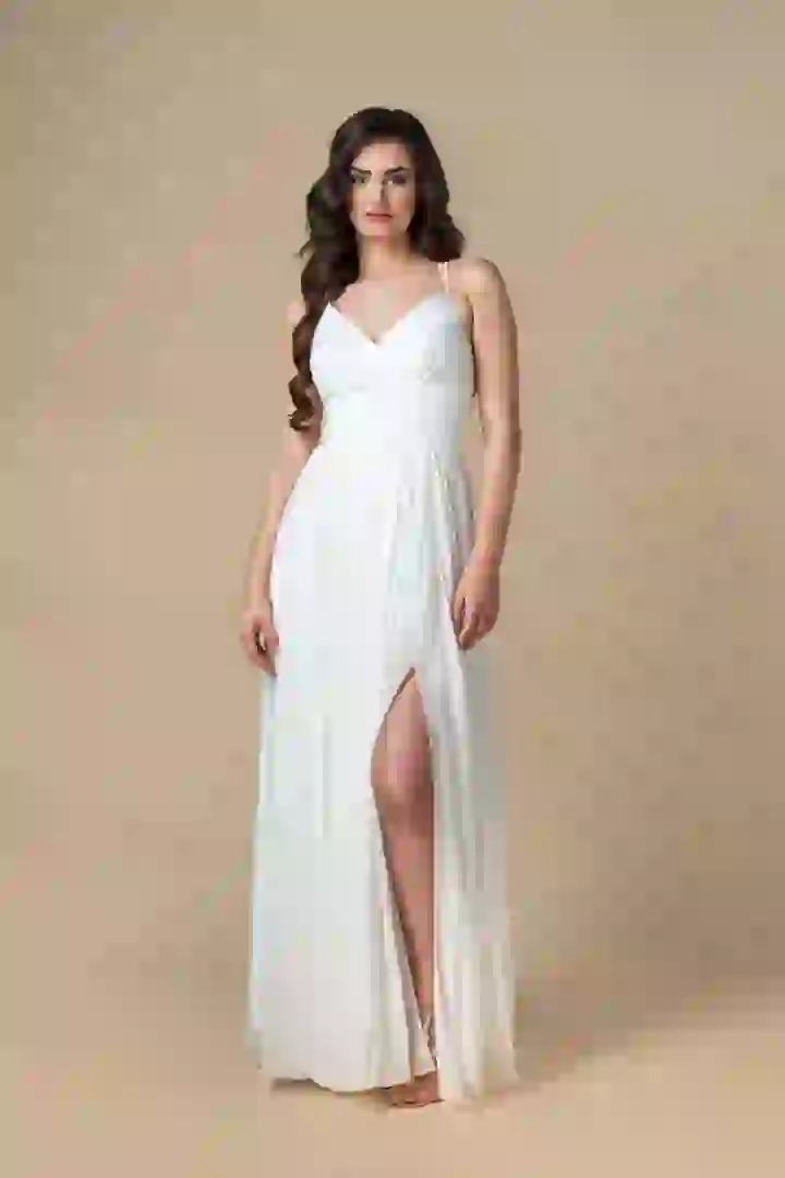 An elegant white woman stands wearing a white dress. She is ready for a clothing swap. Click to change her clothing with AI.