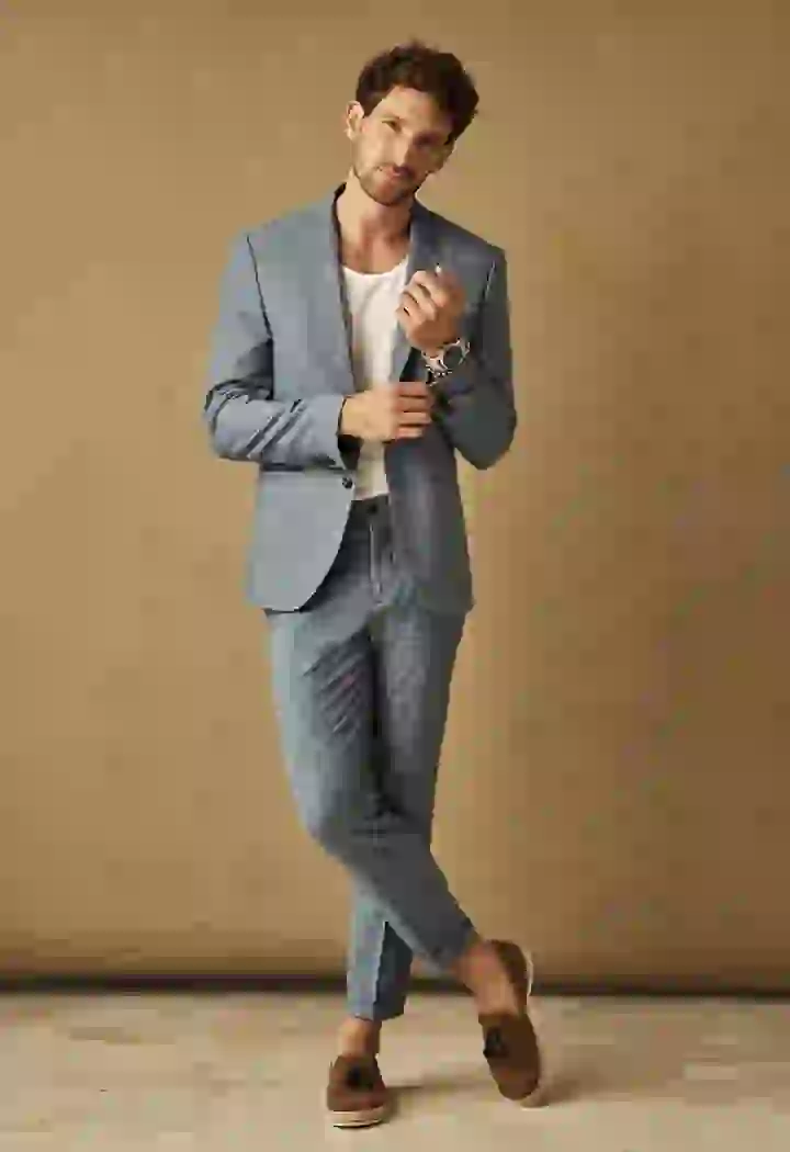 A full-body shot of a clothing swap model, dressed in a gray suit, showcasing how to change clothing.