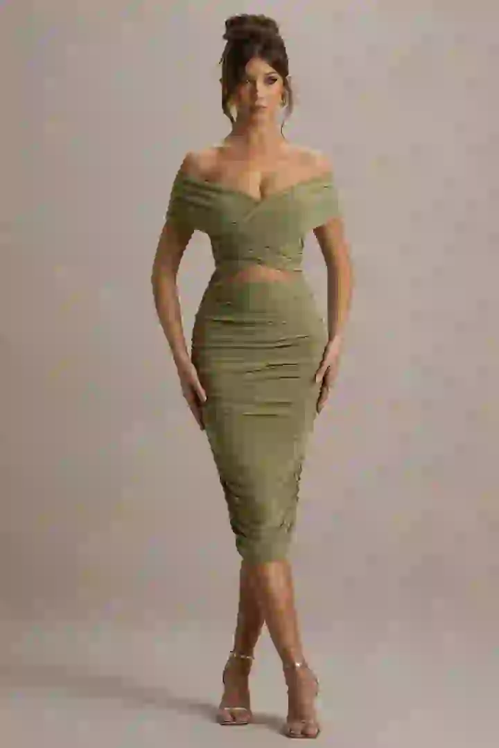 A full-body shot of a clothing swap hot chick, dressed in a green wrap dress, showing how to change clothing.