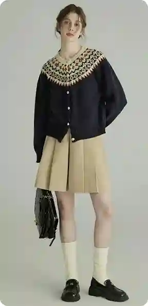 En kvinde i en marineblå strikcardigan med mønstret krave, en beige plisseret nederdel og sorte sko, model for AI clothes swap.